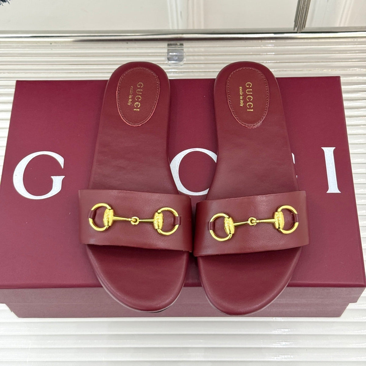 SLIDE SANDALS IN RED CALFSKIN WITH GOLD HARDWARE
